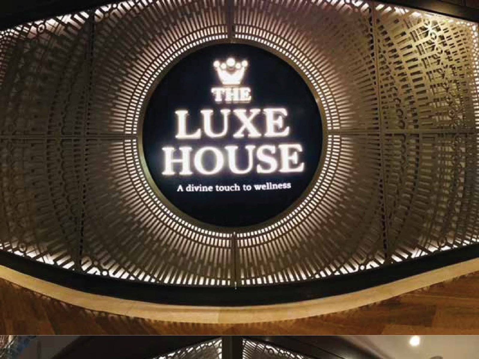 The Luxe House &mdash; illuminated lockup · facade screen